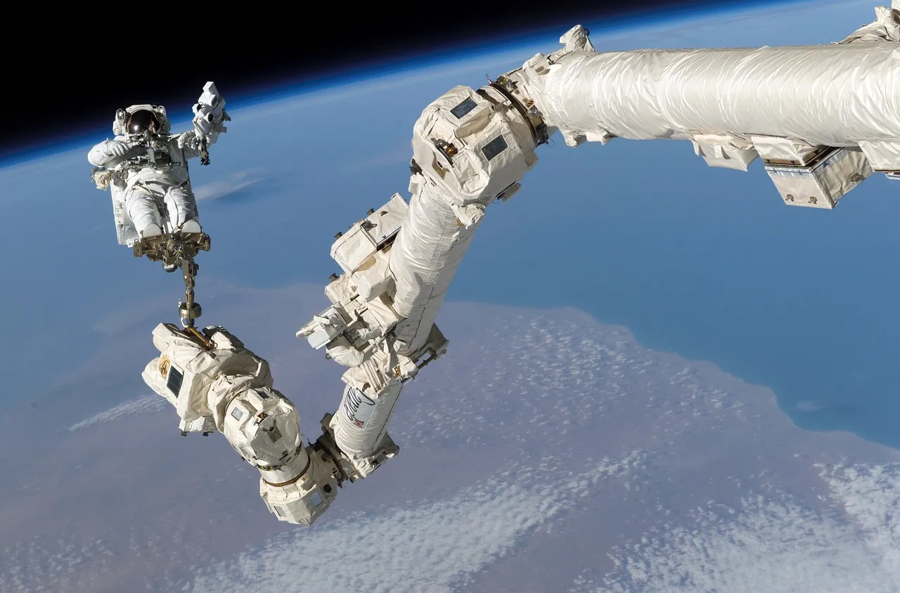 An astronaut works outside the International Space Station