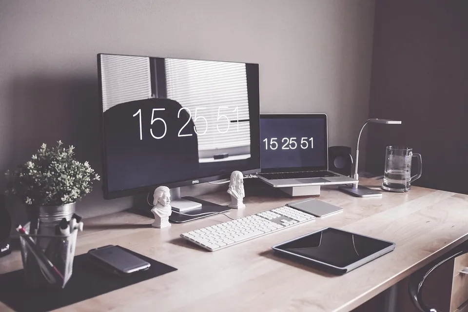 A home-office desk with a tablet and computer