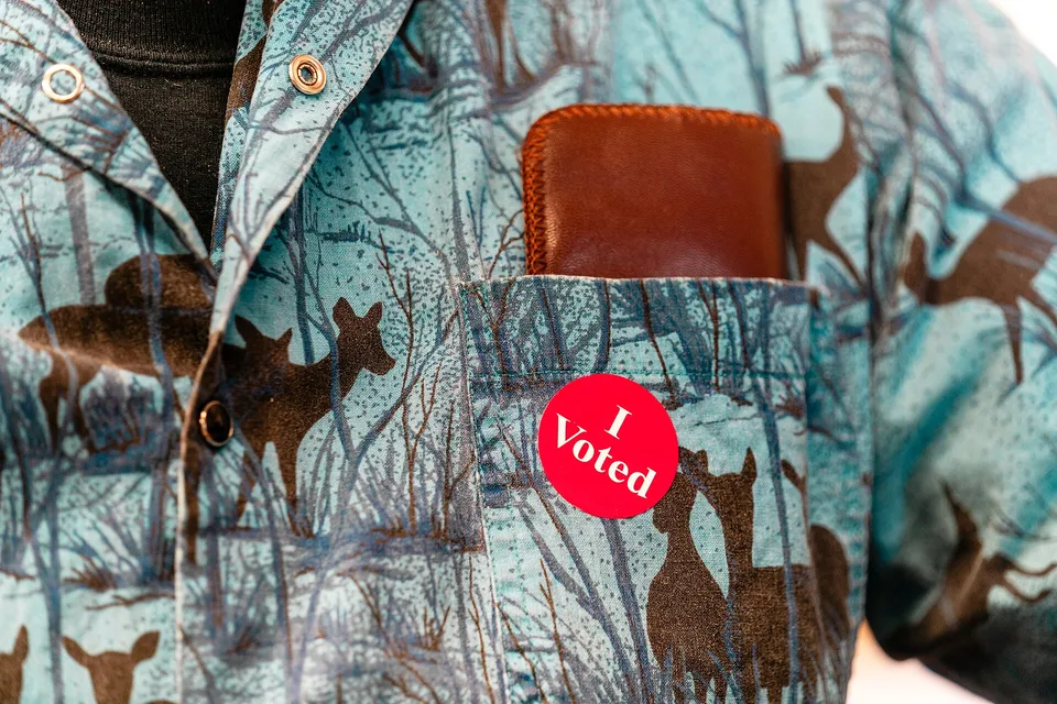 An 'I Voted' sticker on a voter's shirt
