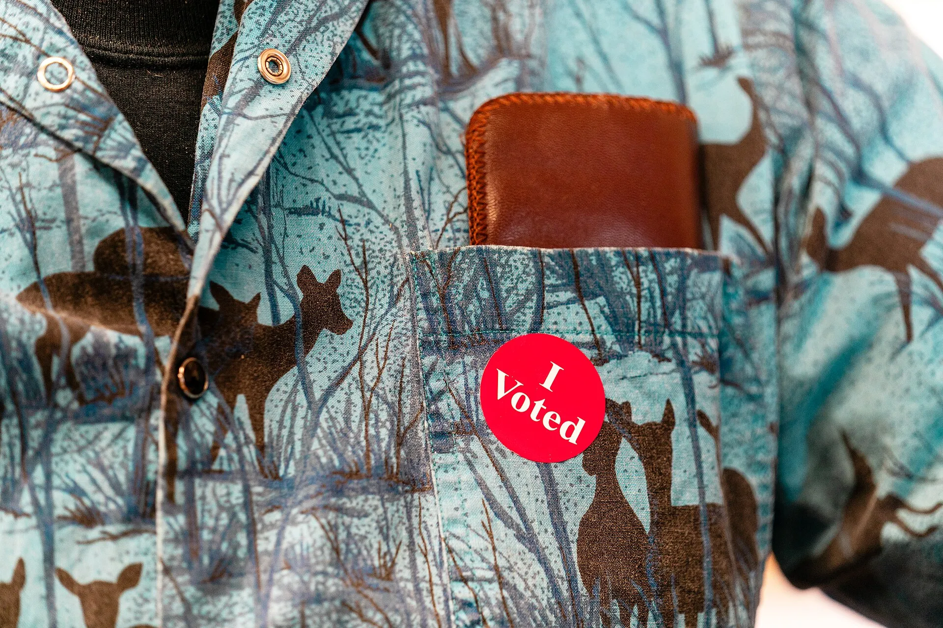 An 'I Voted' sticker on a voter's shirt
